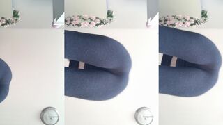 Emi squats in yoga suit over camera